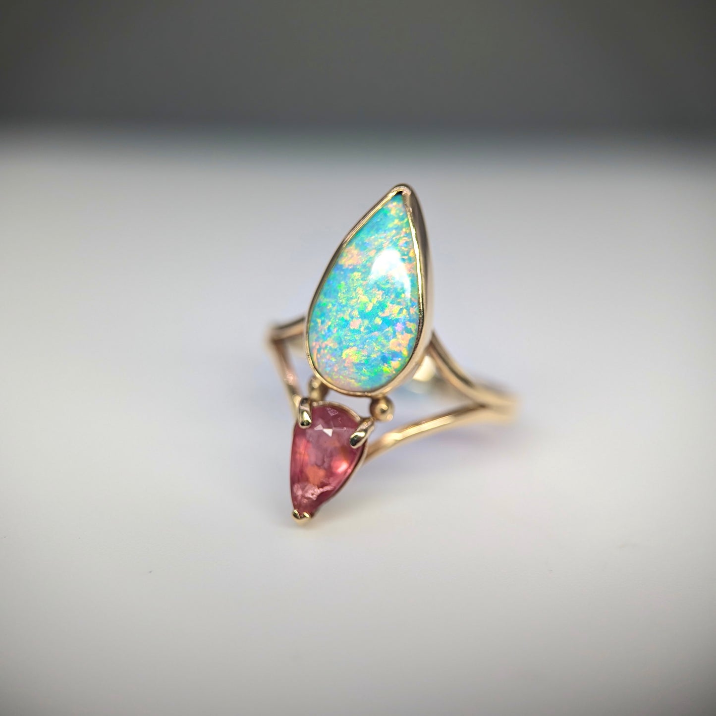 Australian crystal opal and peach tourmaline ring in 9 k yellow gold