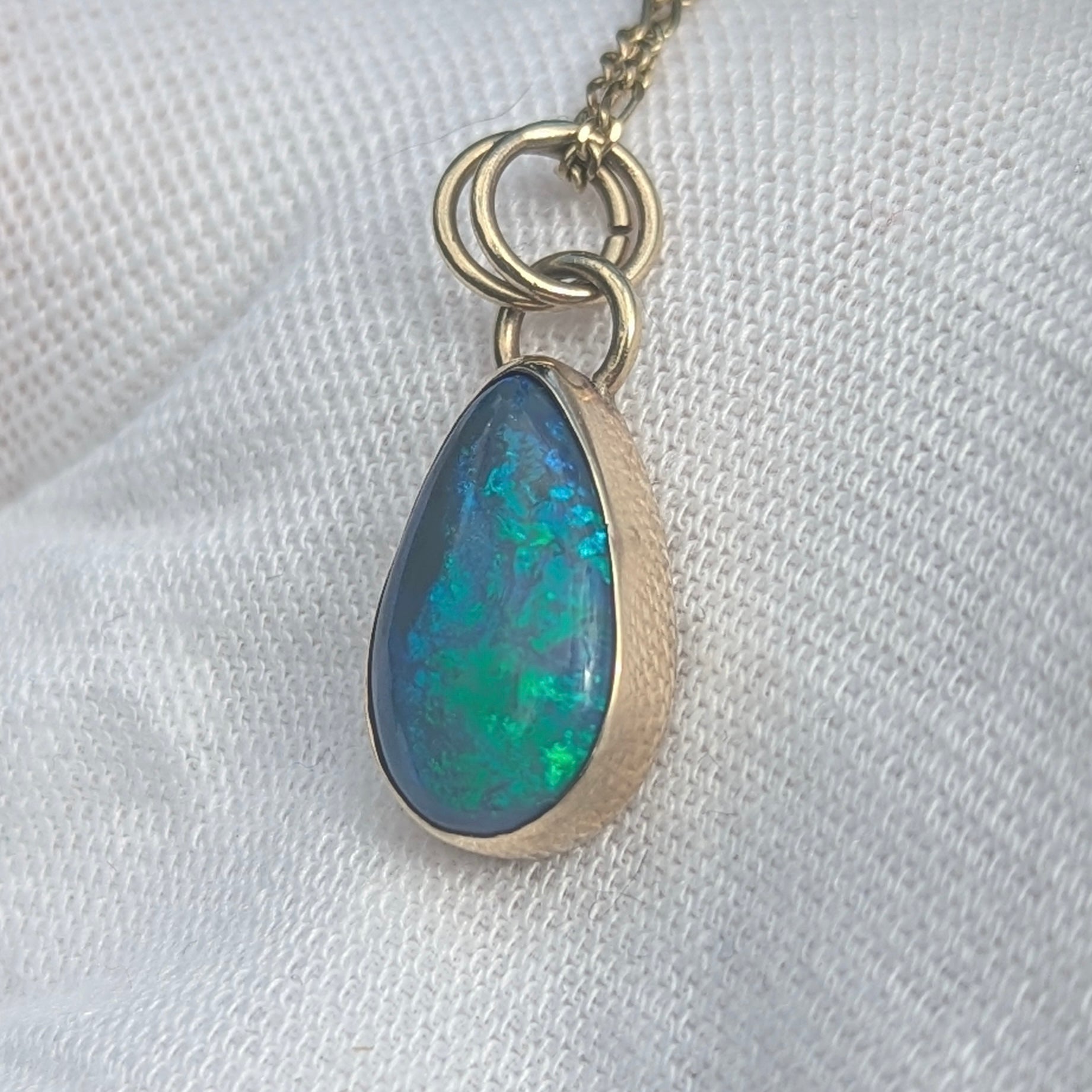 Black Opal Pendant with Blue Green fire in 9K yellow gold