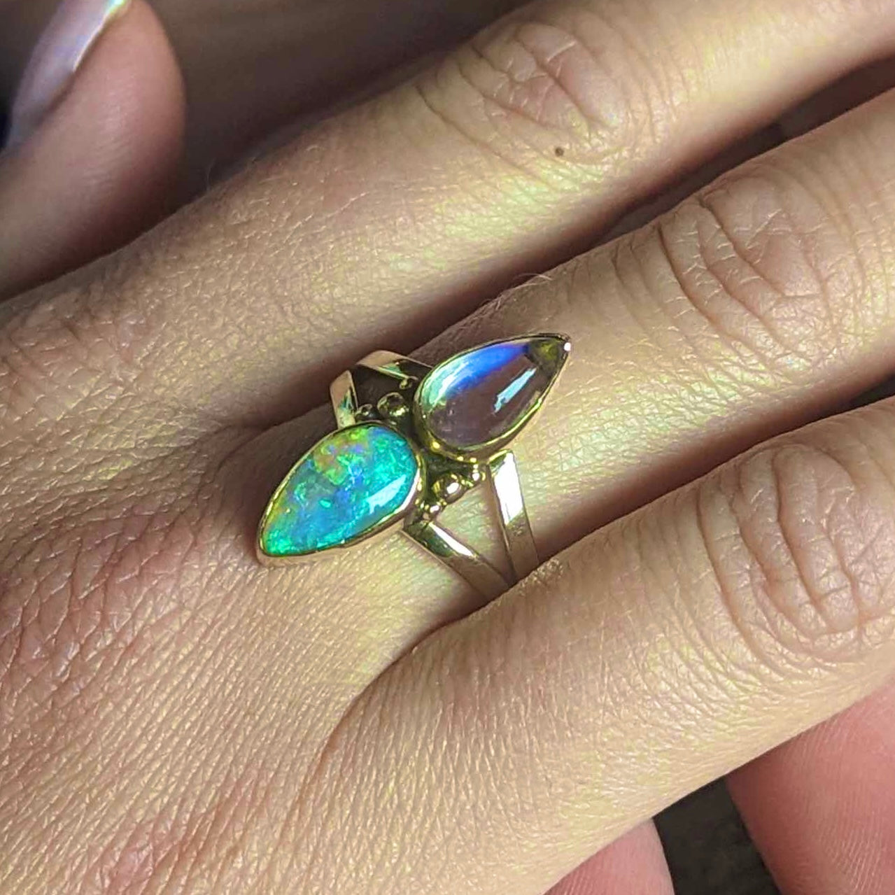 Split shank ring with high grade purple moonstone and green and purple crystal opal in 9K yellow gold