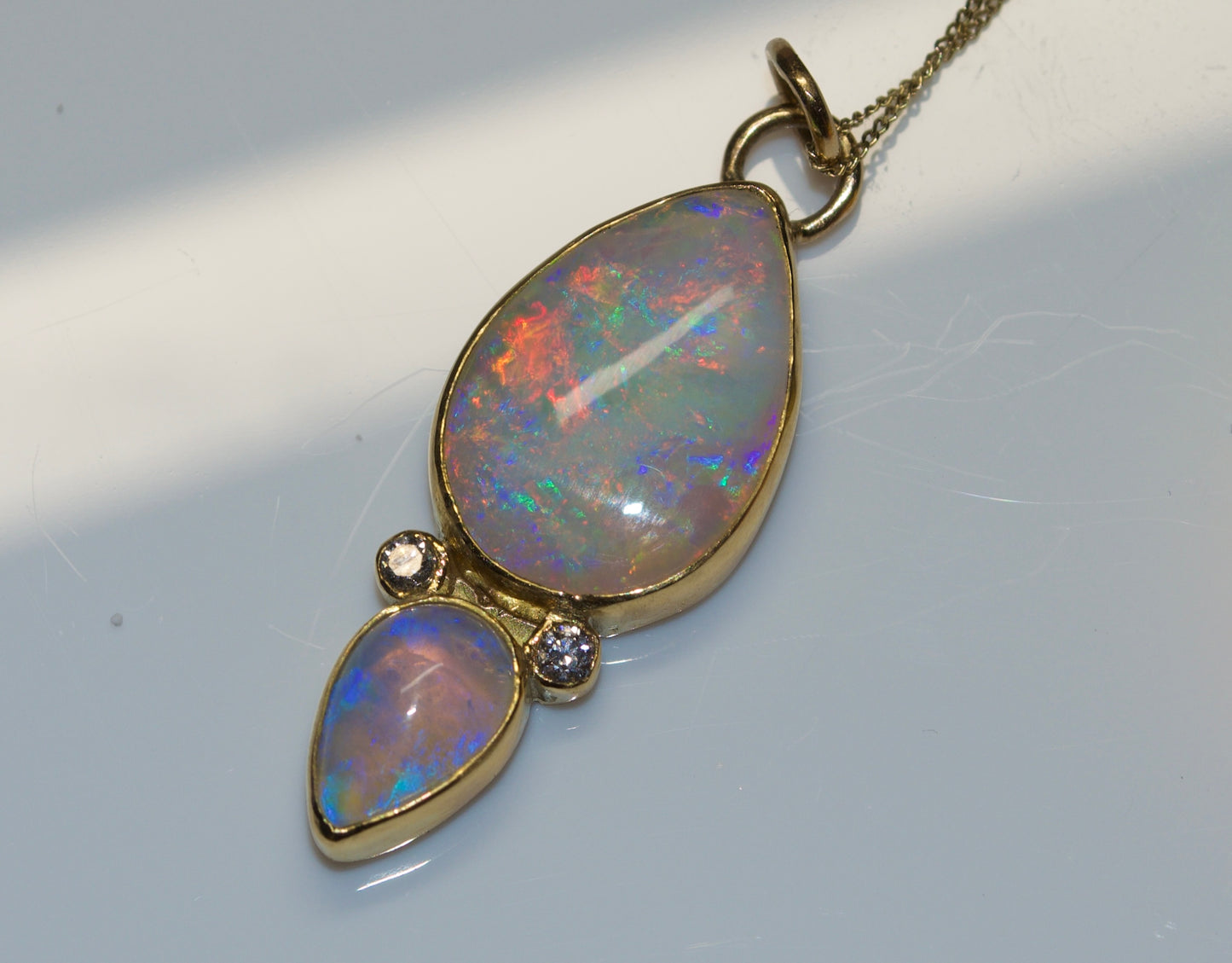 A statement Double Australian Opal Pendant with Accent Diamonds in 18K Yellow Gold . Assay Hallmarked