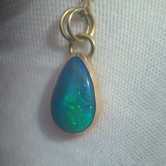 Black Opal Pendant with Blue Green fire in 9K yellow gold