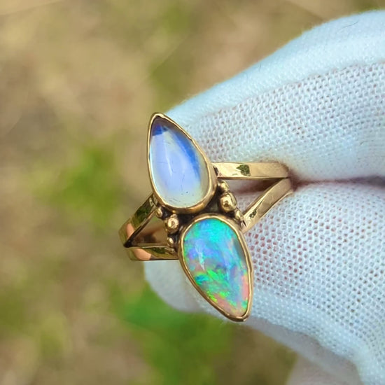 Split shank ring with high grade purple moonstone and green and purple crystal opal in 9K yellow gold